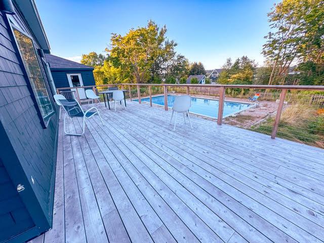 wooden terrace with a fenced in pool