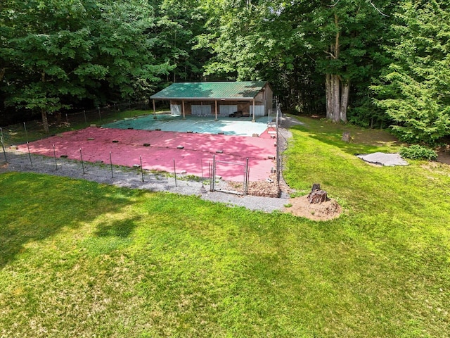 view of community featuring an outbuilding and a yard