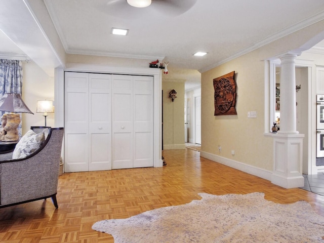 sitting room with crown molding, decorative columns, and light parquet floors