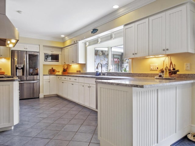 kitchen featuring light tile patterned flooring, appliances with stainless steel finishes, white cabinets, and kitchen peninsula