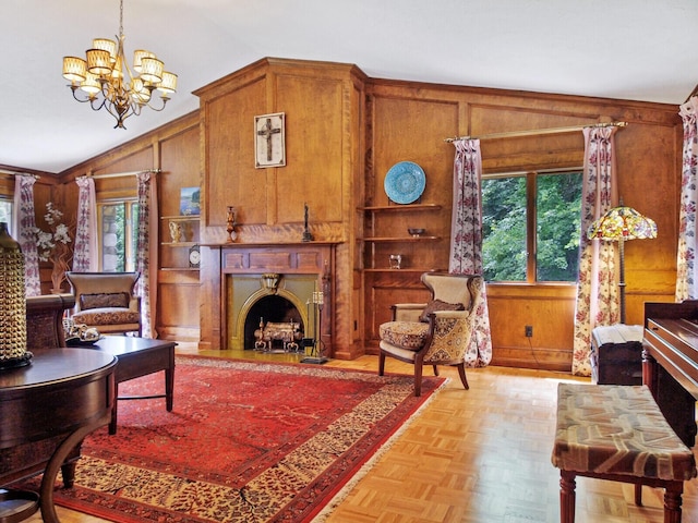 living room featuring lofted ceiling, a notable chandelier, light parquet flooring, and wood walls