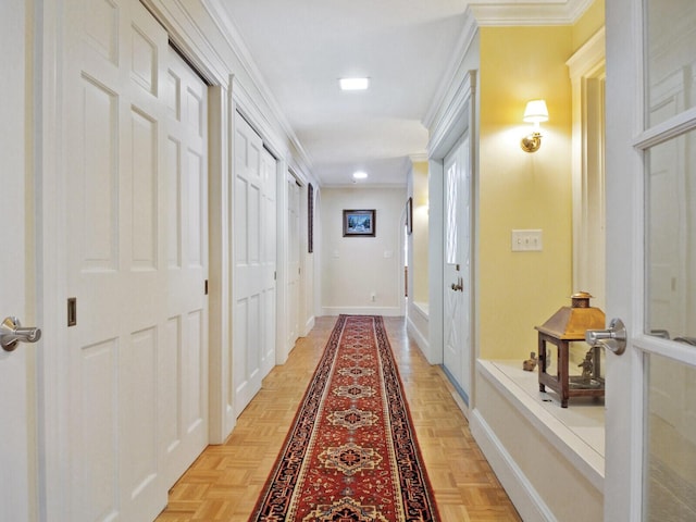 hallway featuring ornamental molding and light parquet flooring