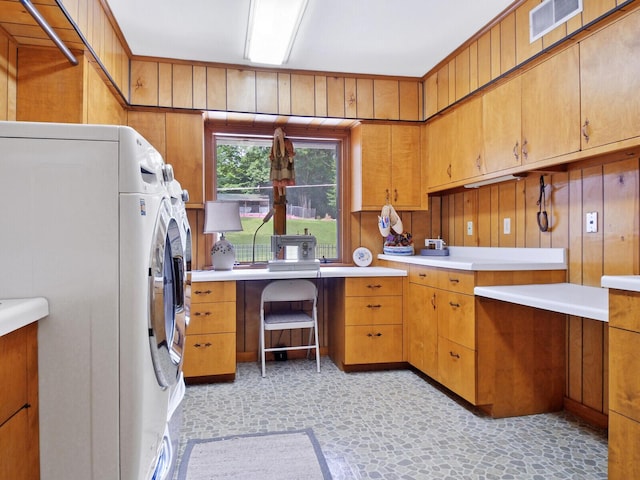 interior space with wooden walls and washing machine and dryer