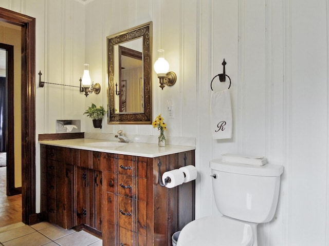 bathroom featuring vanity, tile patterned floors, and toilet