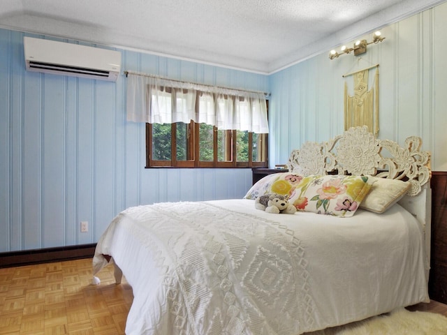 bedroom featuring light parquet flooring, a wall mounted AC, and a textured ceiling