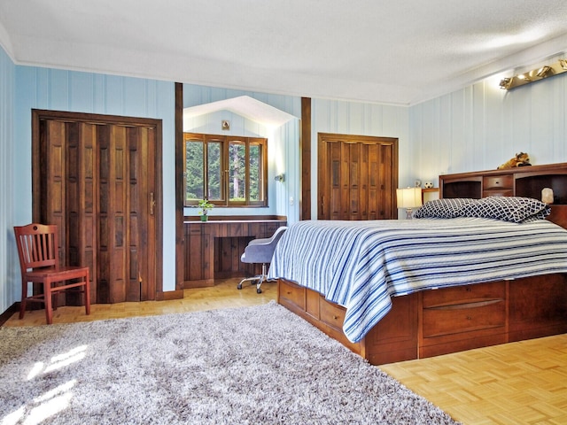 bedroom featuring wood walls