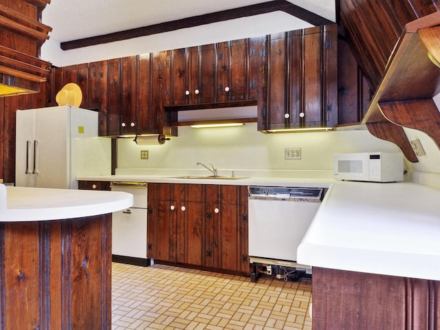 kitchen featuring white appliances, kitchen peninsula, and sink