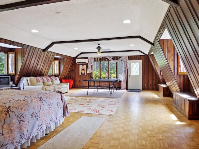 bedroom with light parquet flooring, wooden walls, a wall mounted AC, and lofted ceiling with beams