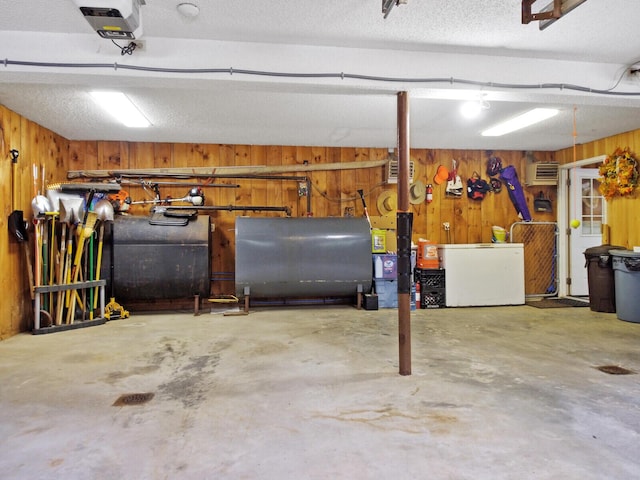 basement with fridge and wooden walls