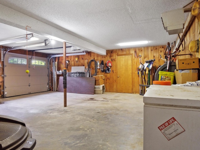 garage with a garage door opener and wooden walls