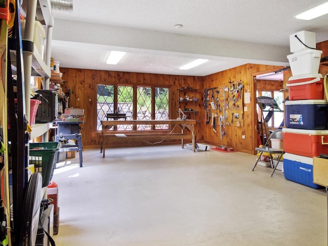 misc room with a workshop area and wood walls