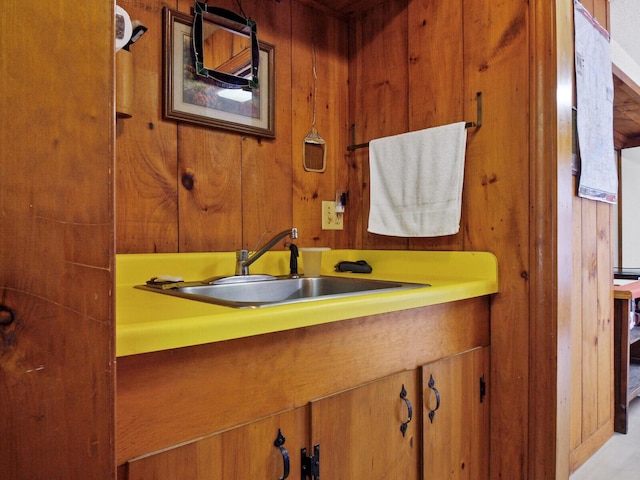 bathroom with vanity and wooden walls