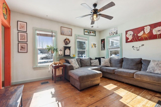 living room featuring ceiling fan and wood-type flooring