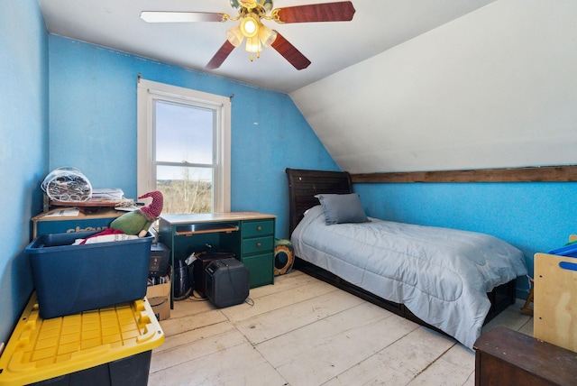 bedroom featuring ceiling fan, light hardwood / wood-style flooring, and lofted ceiling