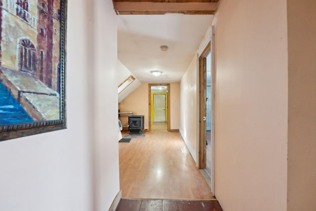 hall featuring vaulted ceiling and hardwood / wood-style floors