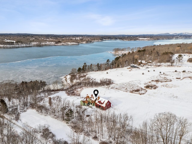 snowy aerial view featuring a water view