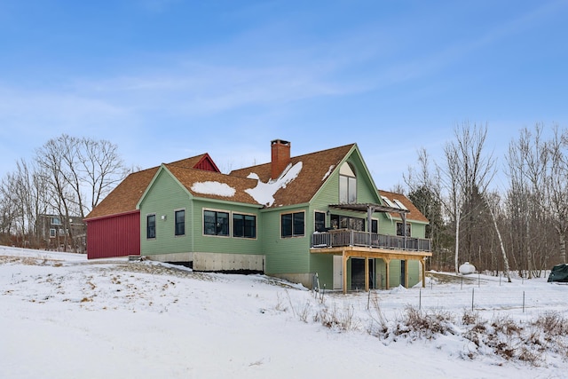 snow covered property featuring a wooden deck