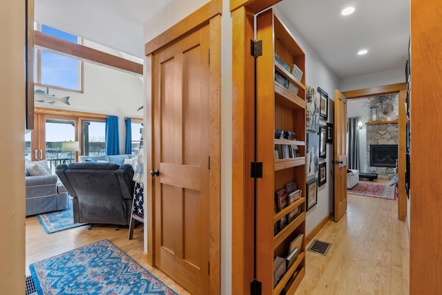 hallway with light hardwood / wood-style flooring