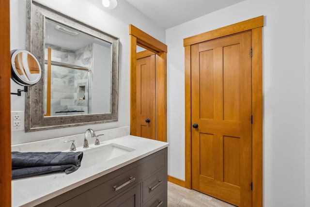 bathroom with a shower with door and vanity