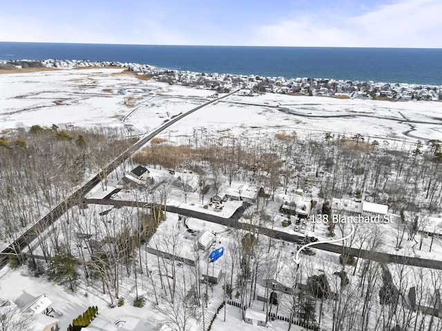 snowy aerial view featuring a water view