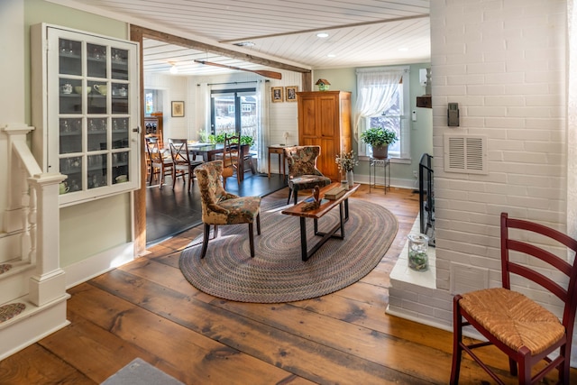 living area with wood ceiling, a healthy amount of sunlight, and hardwood / wood-style floors