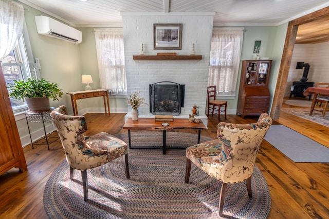 living room featuring ornamental molding, a wood stove, a wall mounted AC, and dark wood-type flooring