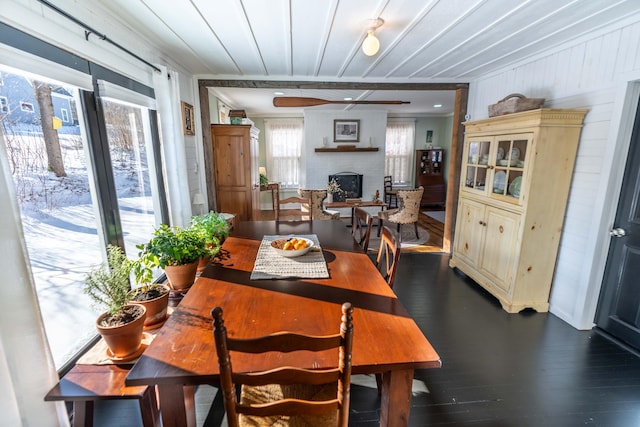 dining space with a fireplace and dark hardwood / wood-style flooring