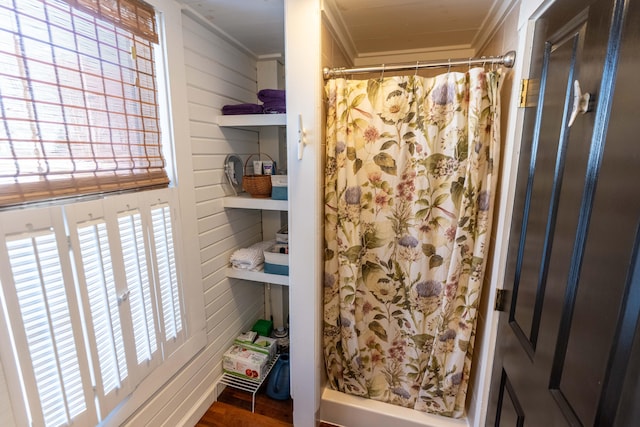 bathroom with crown molding and walk in shower