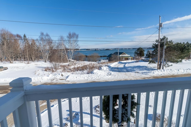 view of snow covered back of property