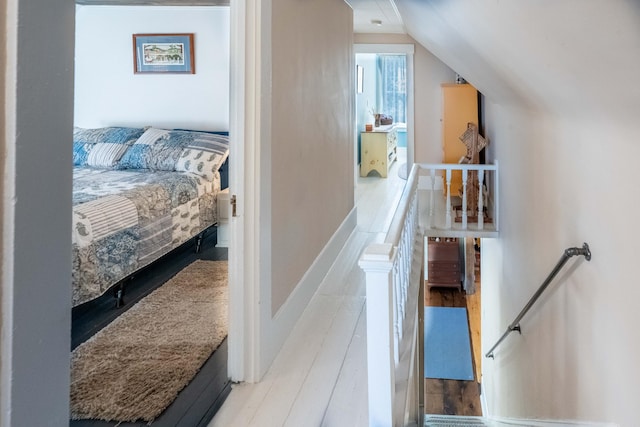 bedroom featuring light hardwood / wood-style flooring and vaulted ceiling