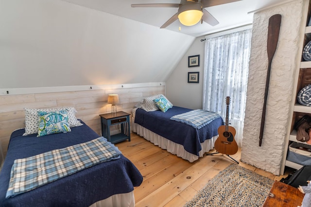 bedroom with vaulted ceiling, light hardwood / wood-style floors, and ceiling fan