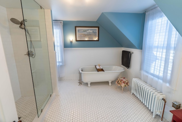 bathroom with radiator and independent shower and bath