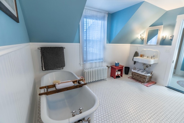 game room featuring lofted ceiling, radiator heating unit, and a washtub