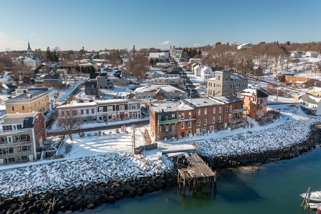 snowy aerial view with a water view