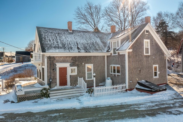 view of snow covered back of property