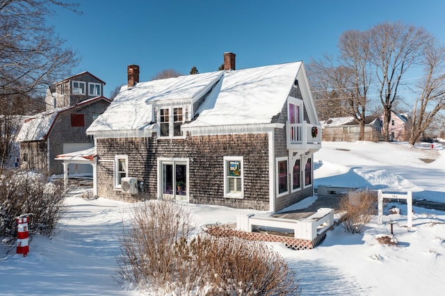 view of snow covered rear of property