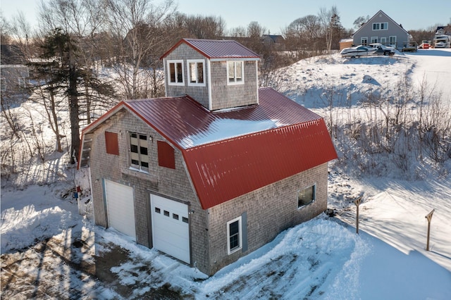 view of snow covered exterior featuring a garage