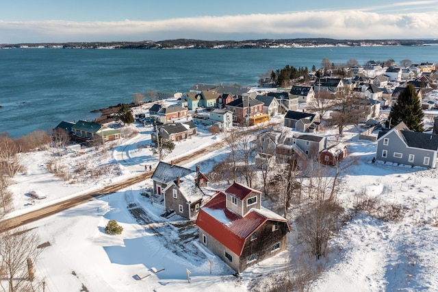 snowy aerial view with a water view