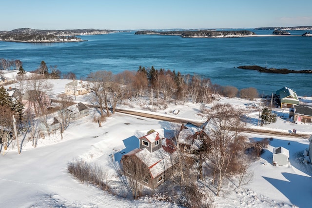 snowy aerial view featuring a water view