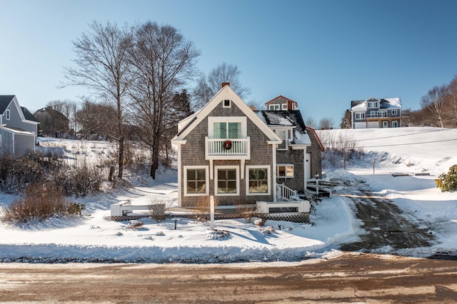 snow covered house with a balcony