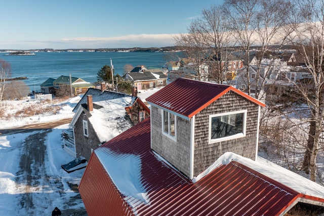 snowy aerial view featuring a water view