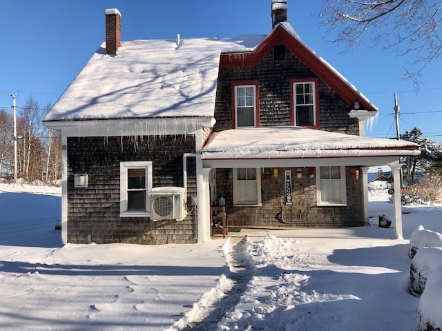 view of front of house with covered porch and ac unit