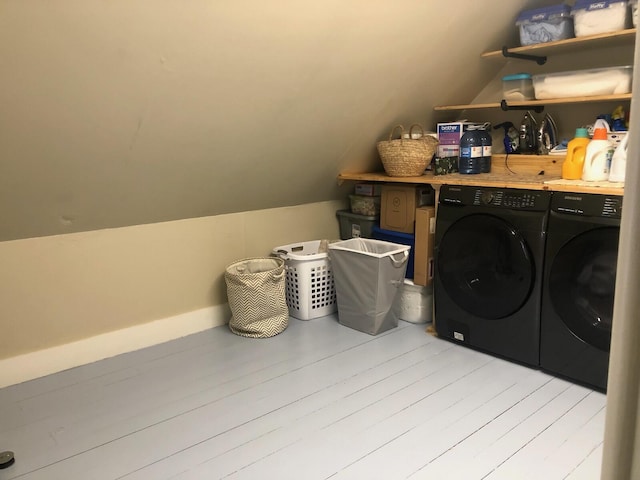 laundry area with independent washer and dryer and light wood-type flooring