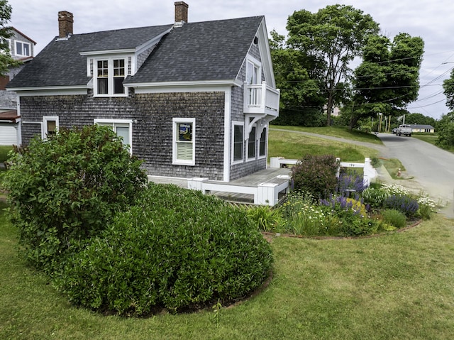 194 Water St, Eastport, ME 04631 - view of property exterior featuring a shingled roof, a chimney, a yard, and a balcony