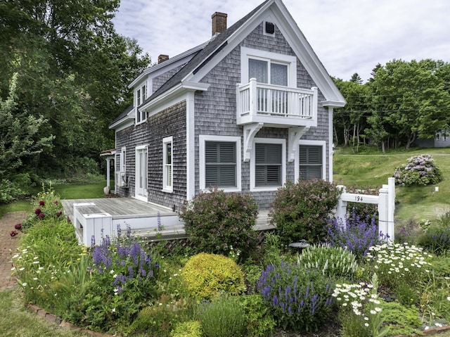 194 Water St, Eastport, ME 04631 - back of property with a chimney, a balcony, and a wooden deck