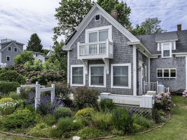 194 Water St, Eastport, ME 04631 - view of front of property featuring a balcony, a chimney, and a shingled roof