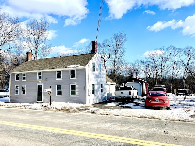 view of front facade with an outbuilding and a garage