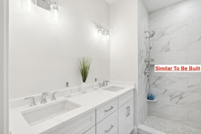 bathroom with vanity and a tile shower