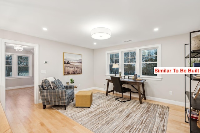 office with light hardwood / wood-style flooring