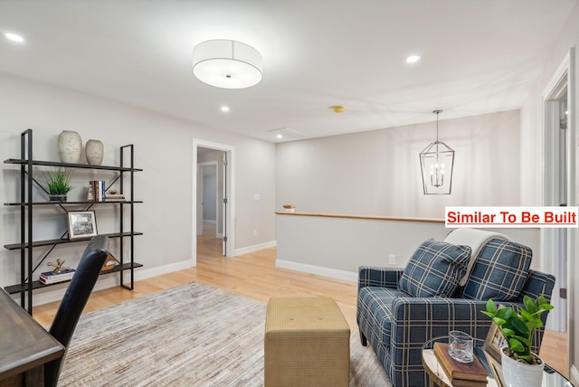 home office featuring hardwood / wood-style floors and a notable chandelier